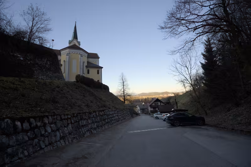 The street and mostly empty parking spots behind the church in Sora.
